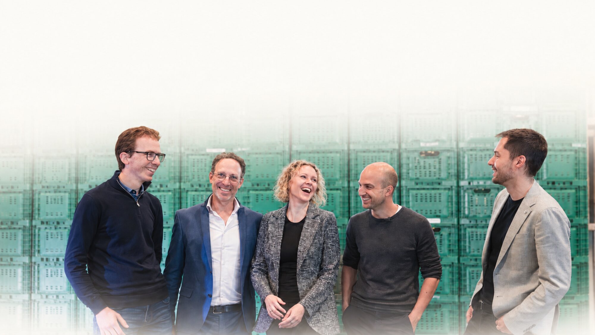 The FOOD FOUNDERS Studio team together in front of stacked produce crates